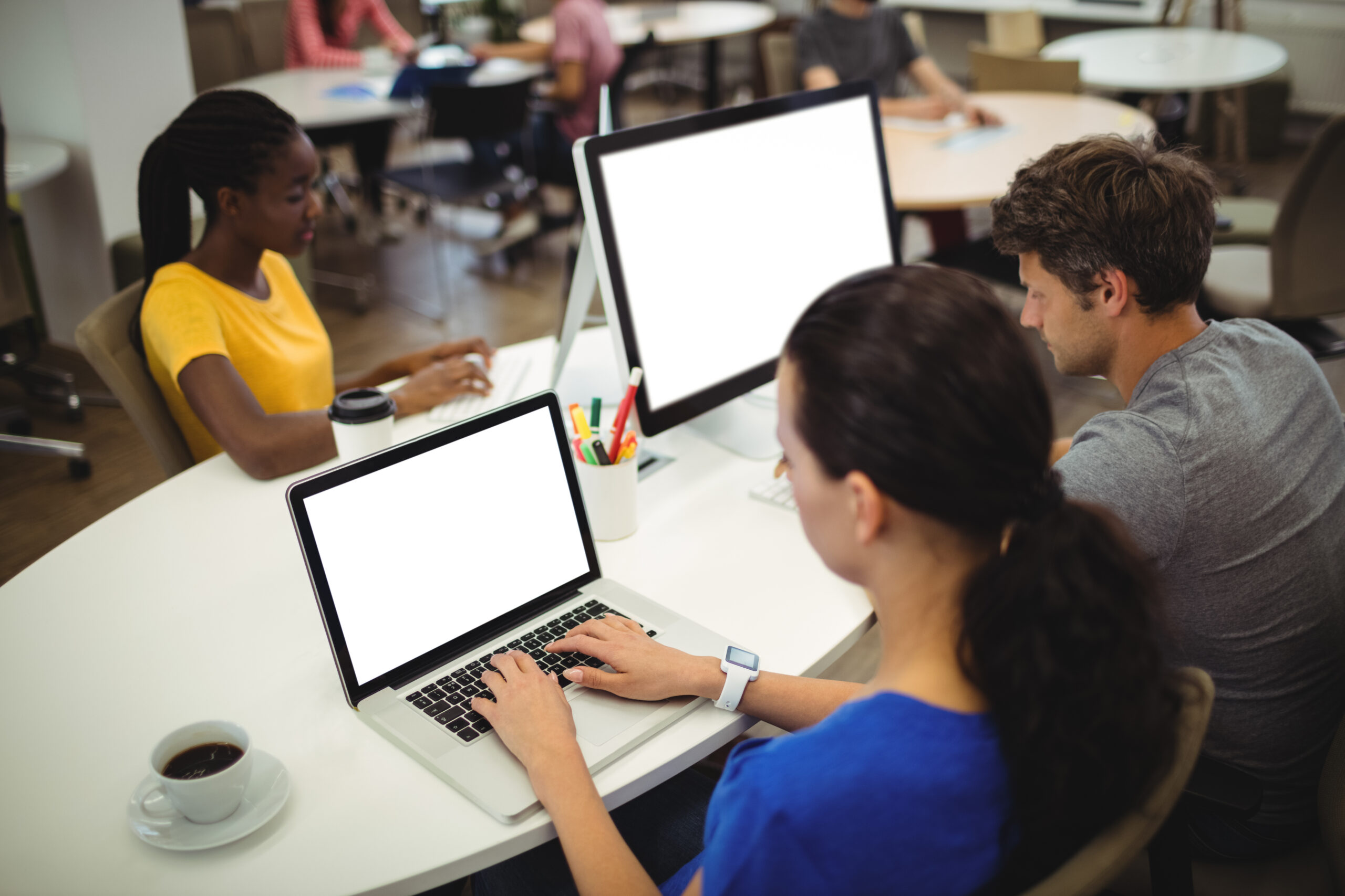 Woman using laptop at her desk in the office